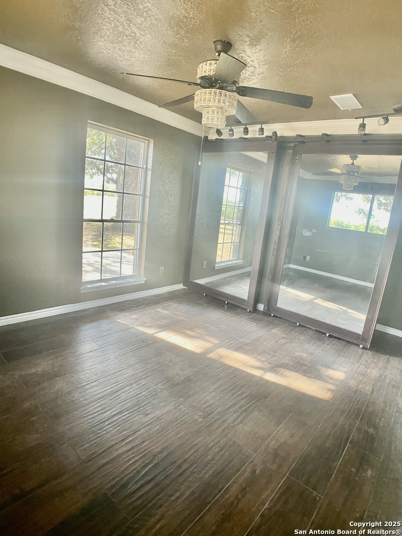 3010 Triple Tree Drive China Grove, TX 78263 - Photo 11 of 18 an empty room with wooden floor and windows
