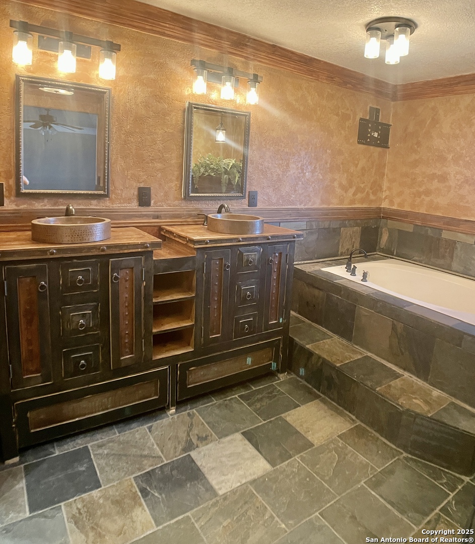 3010 Triple Tree Drive China Grove, TX 78263 - Photo 14 of 18 a spacious bathroom with a sink a vanity and a mirror