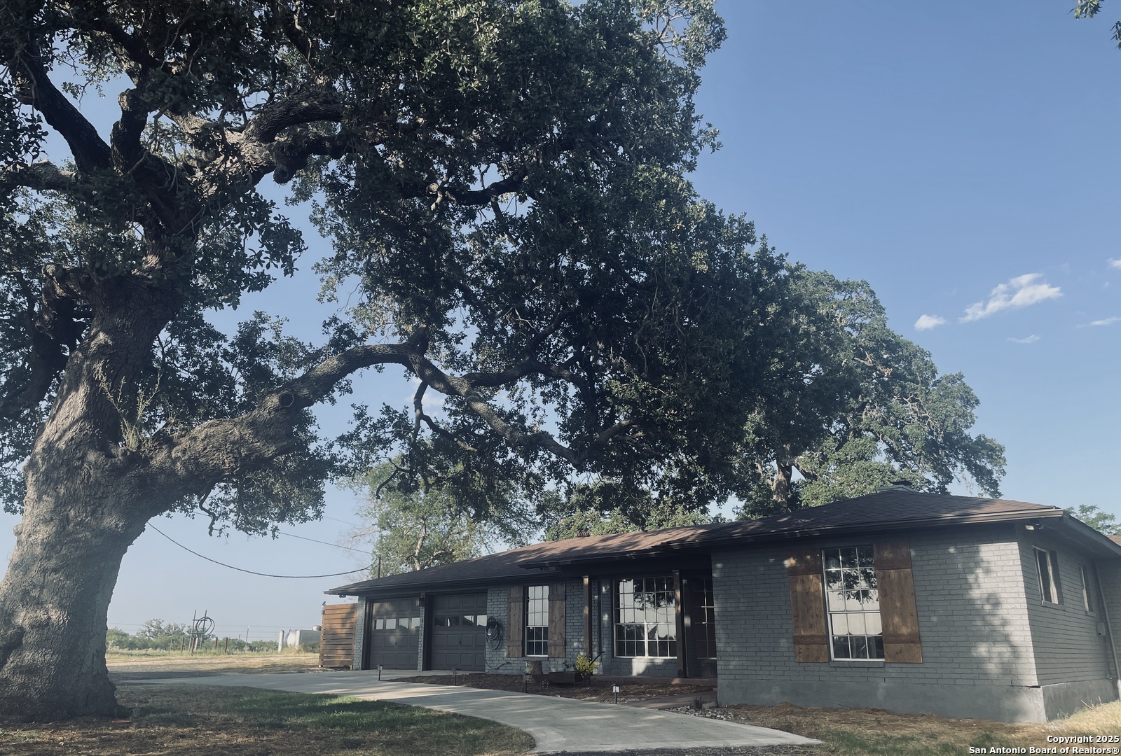 3010 Triple Tree Drive China Grove, TX 78263 - Photo 2 of 18 a front view of a house with a garden