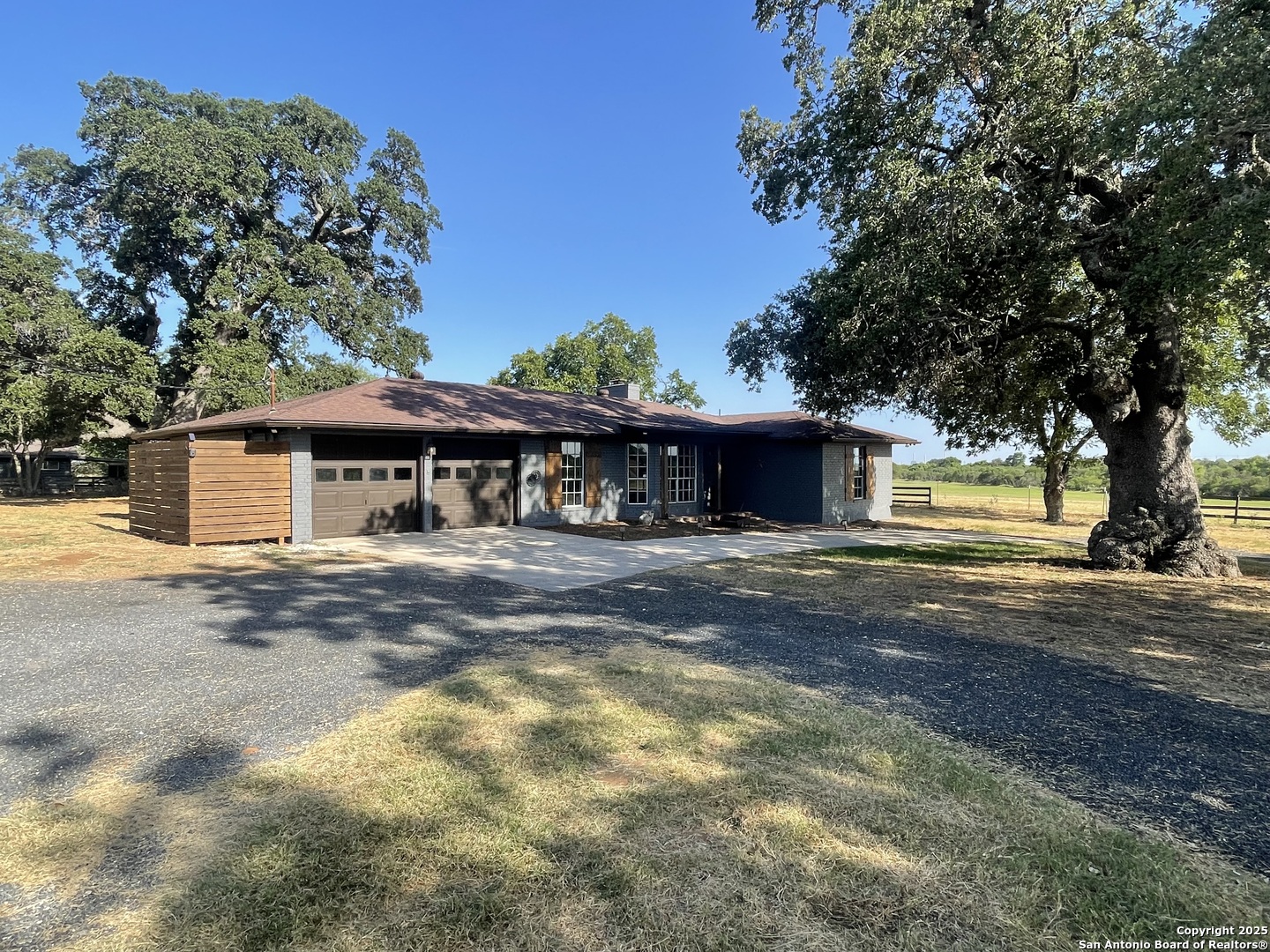3010 Triple Tree Drive China Grove, TX 78263 - Photo 3 of 18 a front view of a house with a yard and a garage