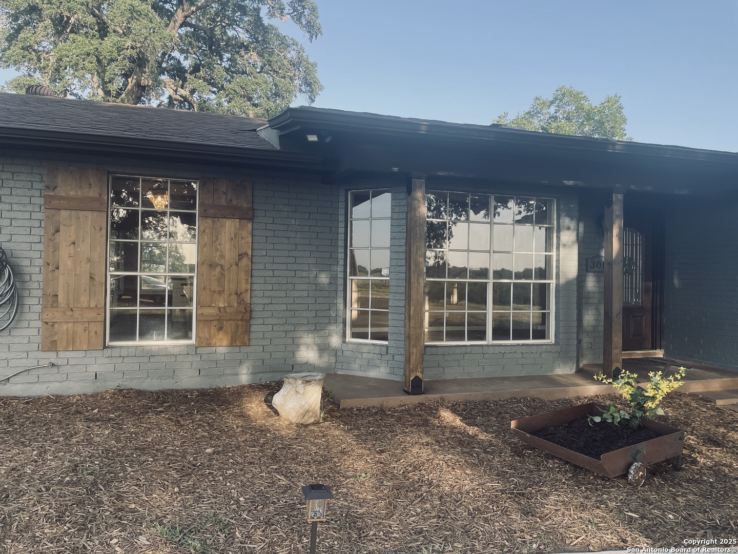 3010 Triple Tree Drive China Grove, TX 78263 - Photo 4 of 18 a front view of a house with a yard and potted plants