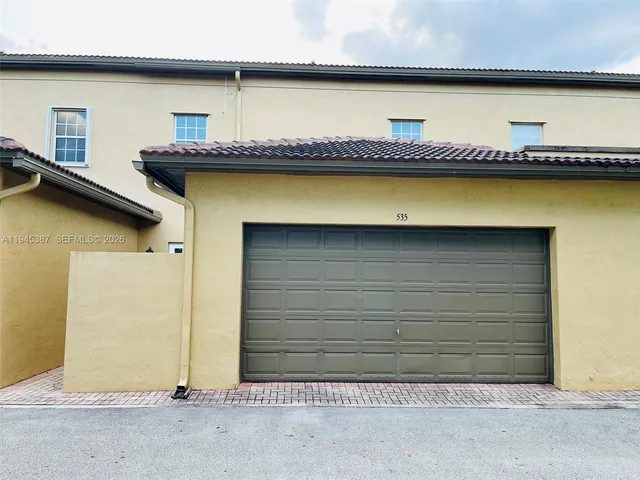 a front view of a house with garage