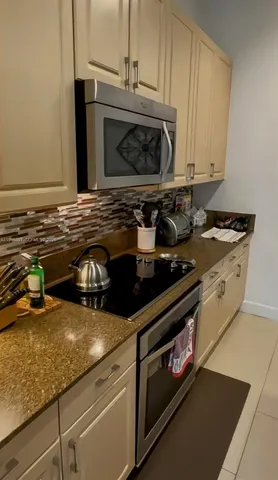 a kitchen with a stove and a microwave