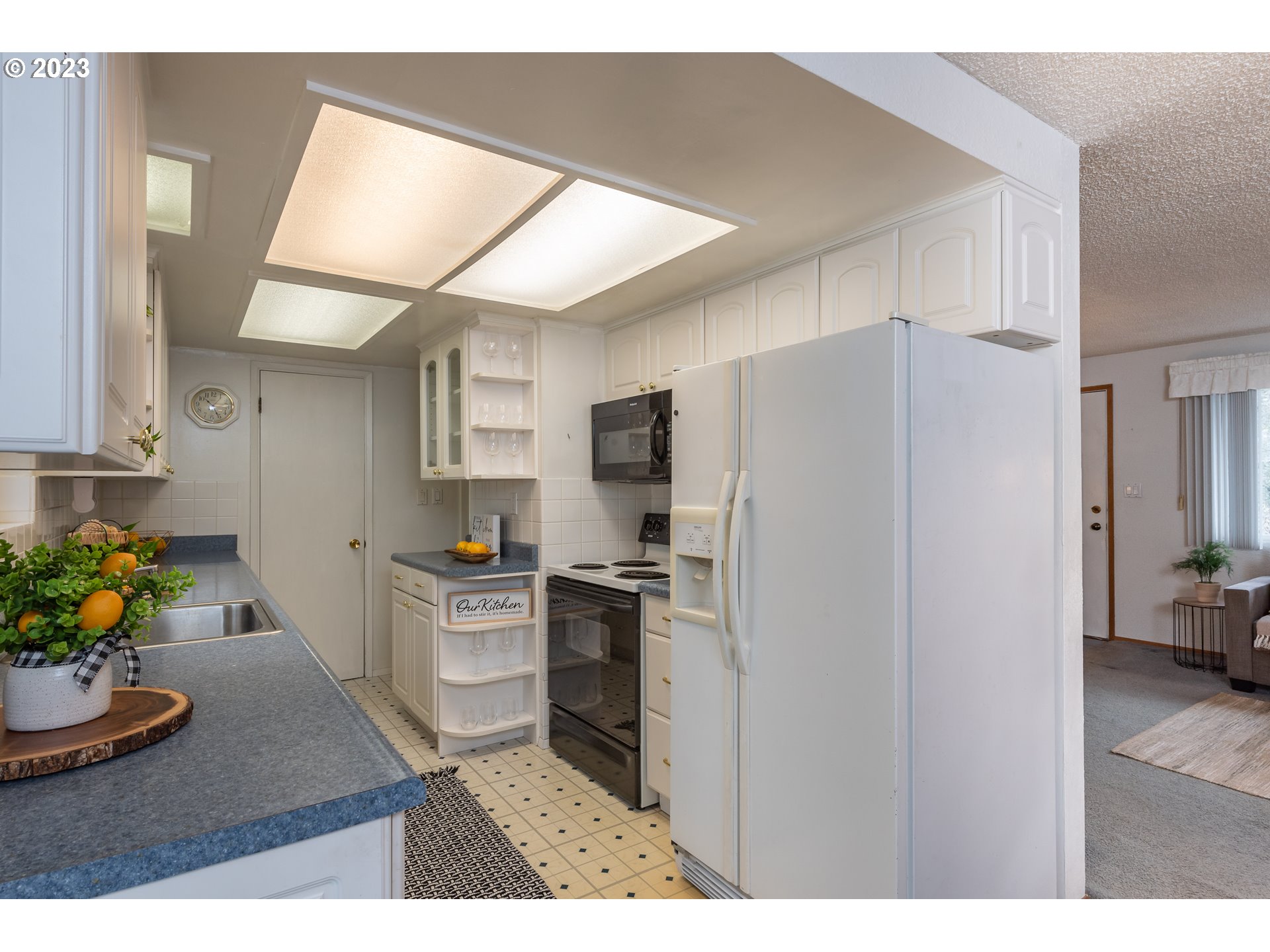 2434 Southwest 328th Street Federal Way, WA 98023 - Photo 13 of 31 a kitchen with stainless steel appliances kitchen island granite countertop a refrigerator a stove and a sink