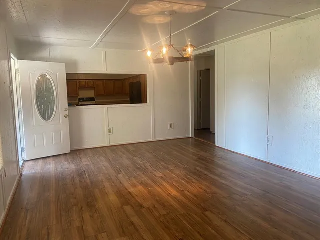 a view of a utility room with wooden floor and windows