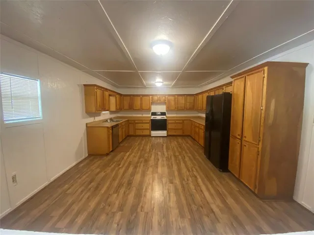 a view of a kitchen with wooden floor