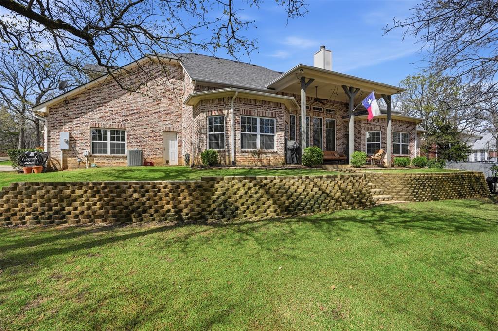 9651 Yellow Rose Lane Pilot Point, TX 76258 - Photo 32 of 38 a front view of a house with a yard