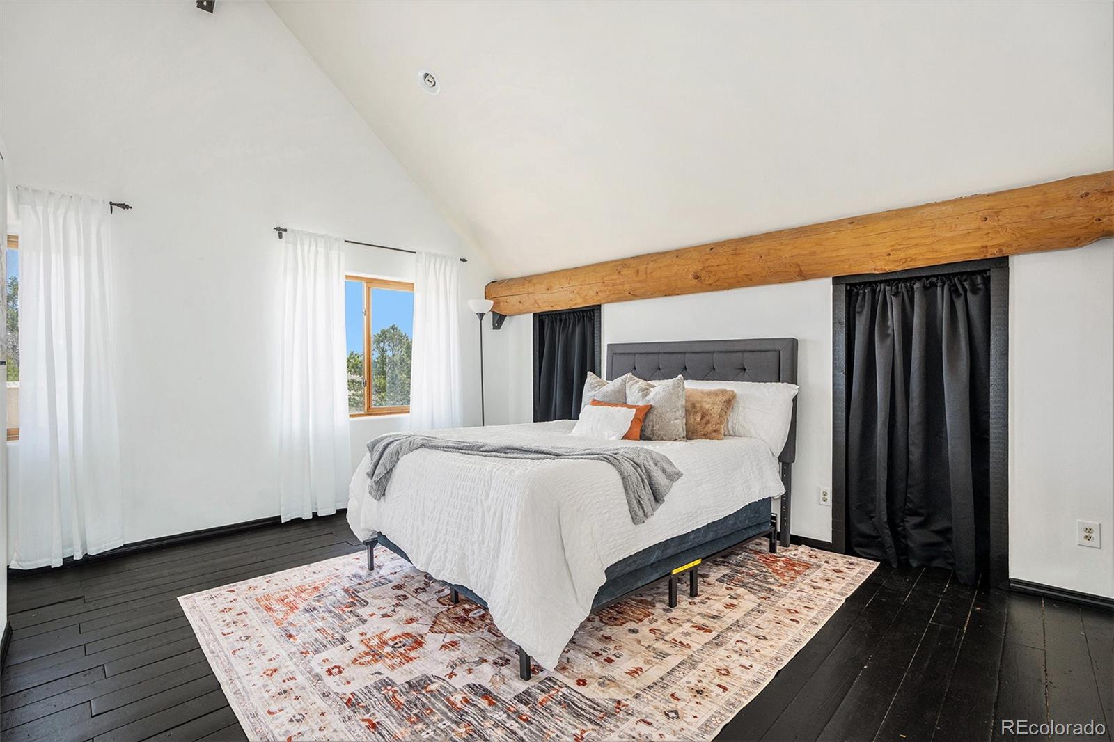 13485 Woodlake Road Elbert, CO 80106 - Photo 11 of 25 a bed sitting in a bedroom next to a window