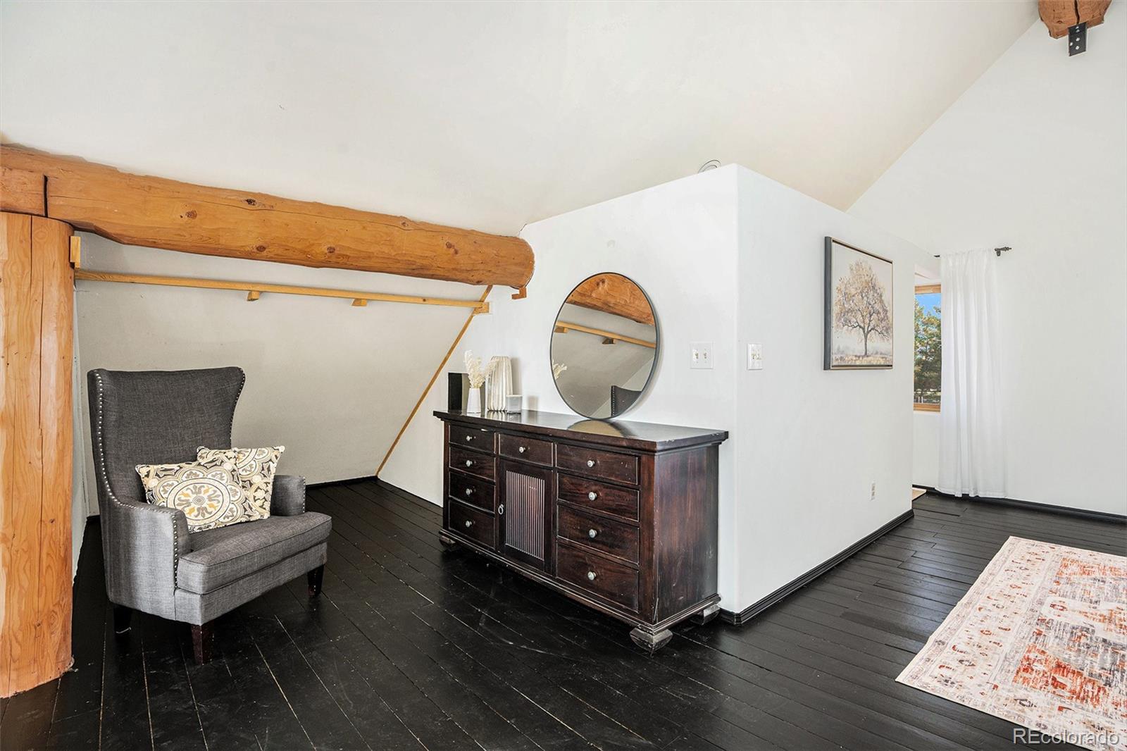 13485 Woodlake Road Elbert, CO 80106 - Photo 13 of 25 a living room with furniture and a wooden floor