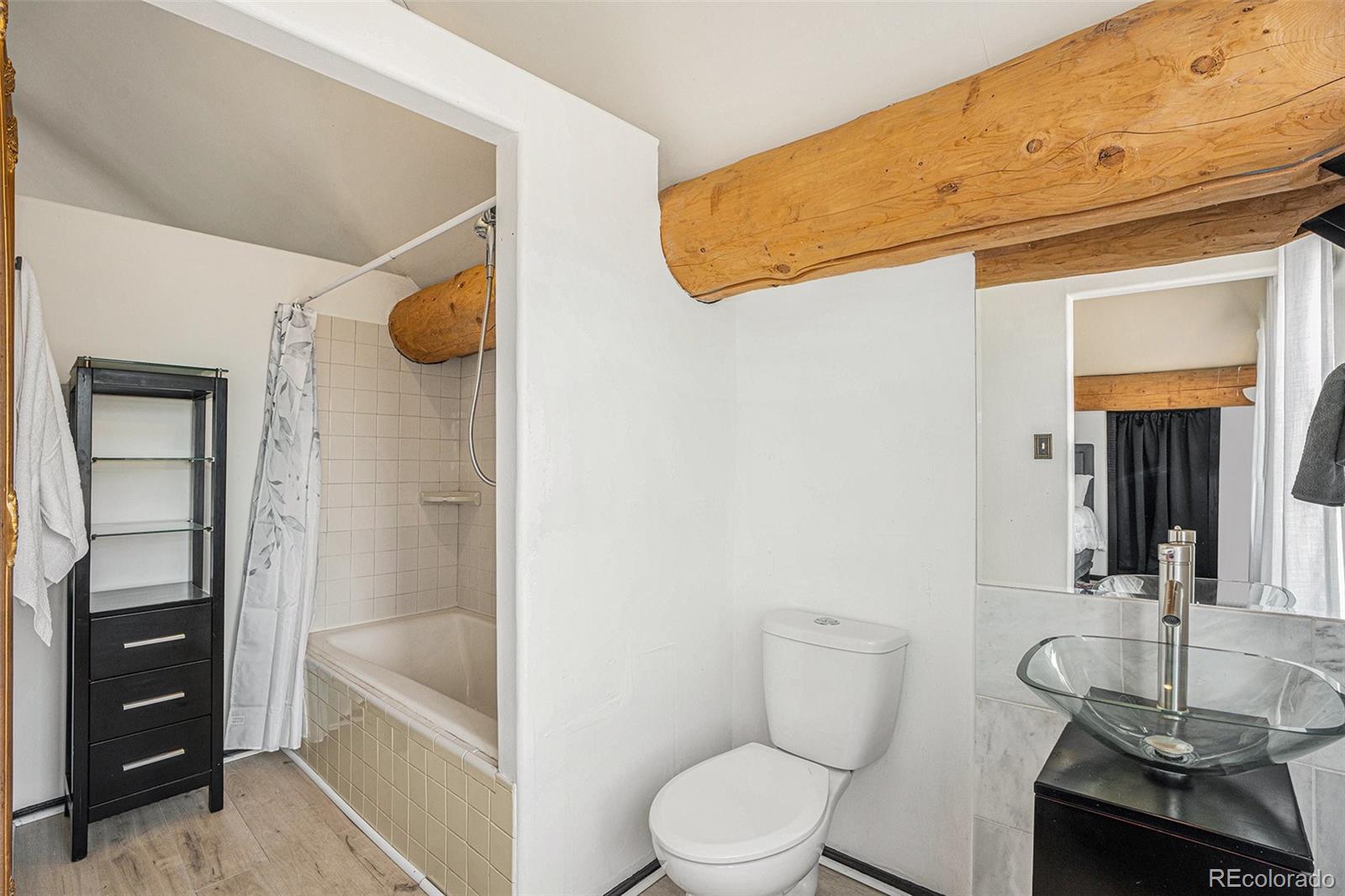 13485 Woodlake Road Elbert, CO 80106 - Photo 14 of 25 a bathroom with a toilet a sink and mirror