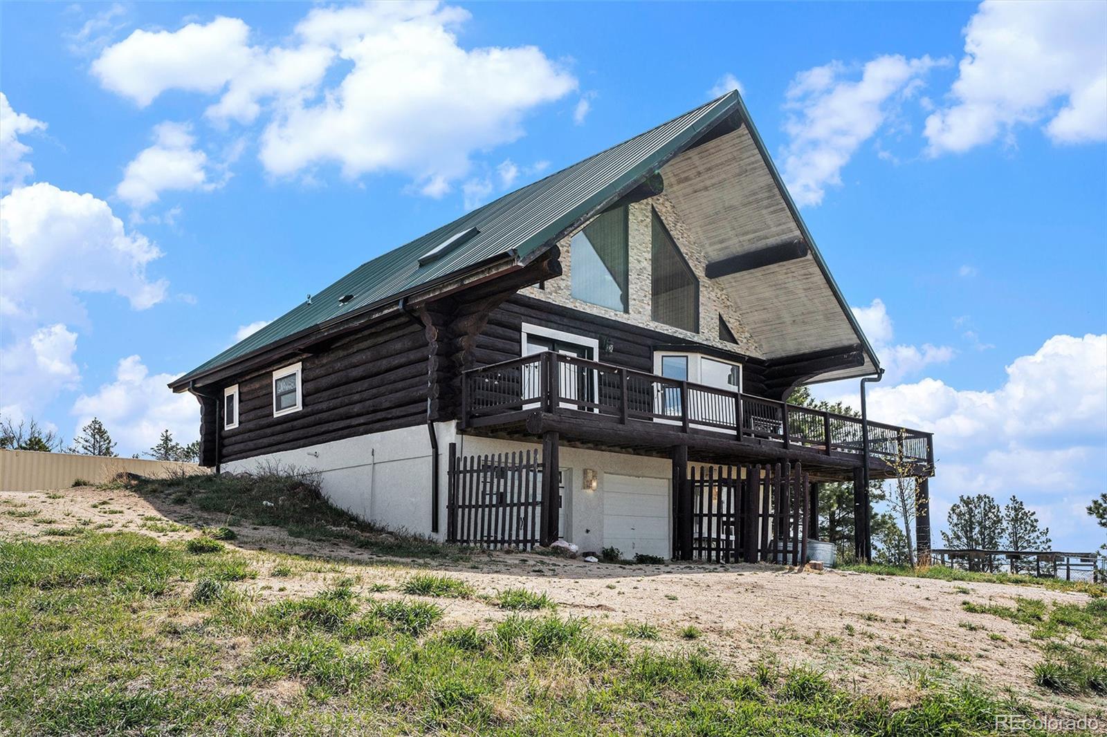 13485 Woodlake Road Elbert, CO 80106 - Photo 21 of 25 a front view of a house with a yard