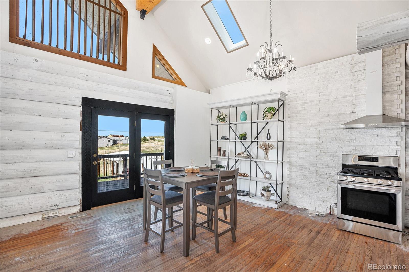 13485 Woodlake Road Elbert, CO 80106 - Photo 5 of 25 a view of a dining room with furniture and chandelier