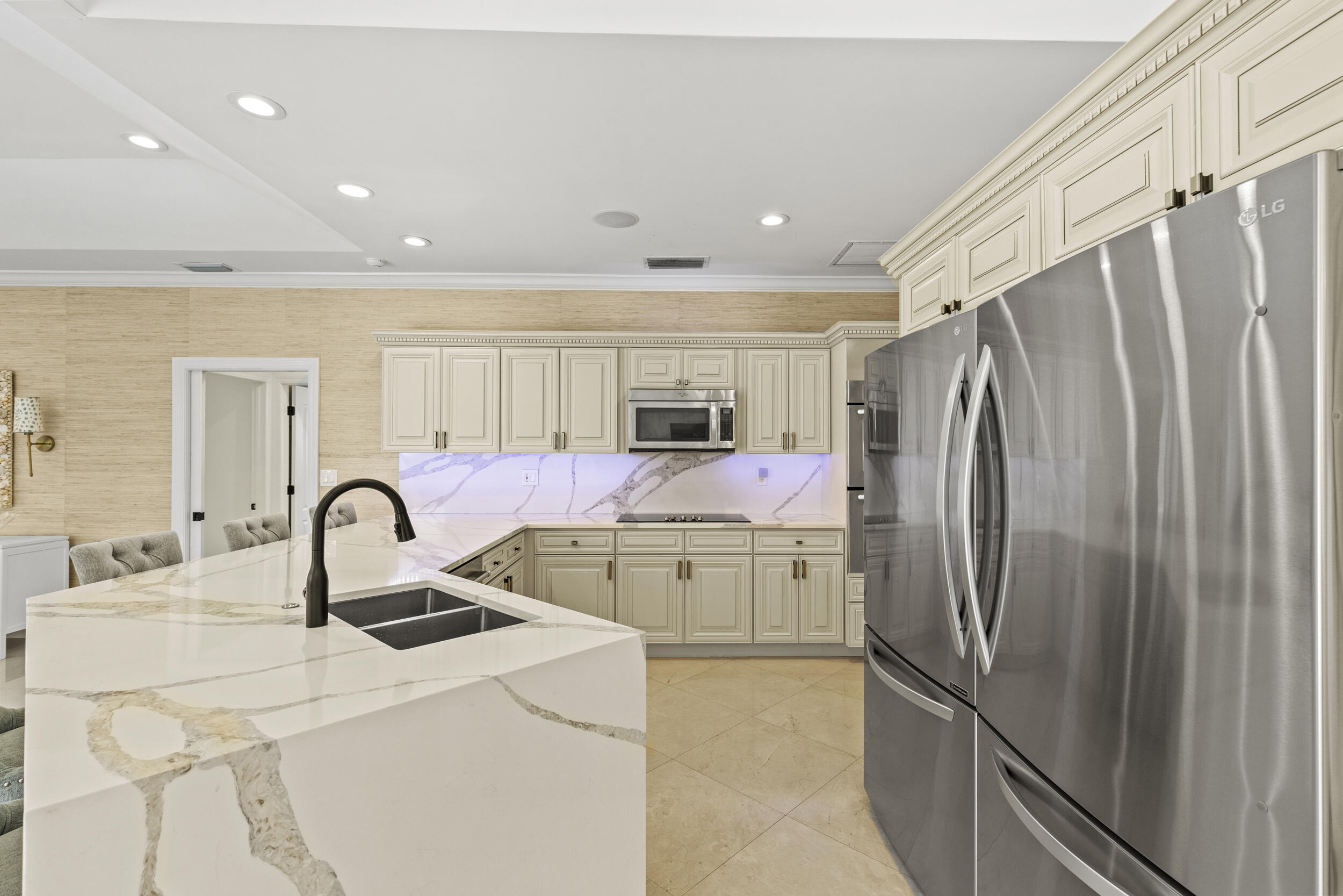 10431 Stonebridge Boulevard Boca Raton, FL 33498 - Photo 14 of 52 a kitchen with stainless steel appliances a refrigerator sink and cabinets