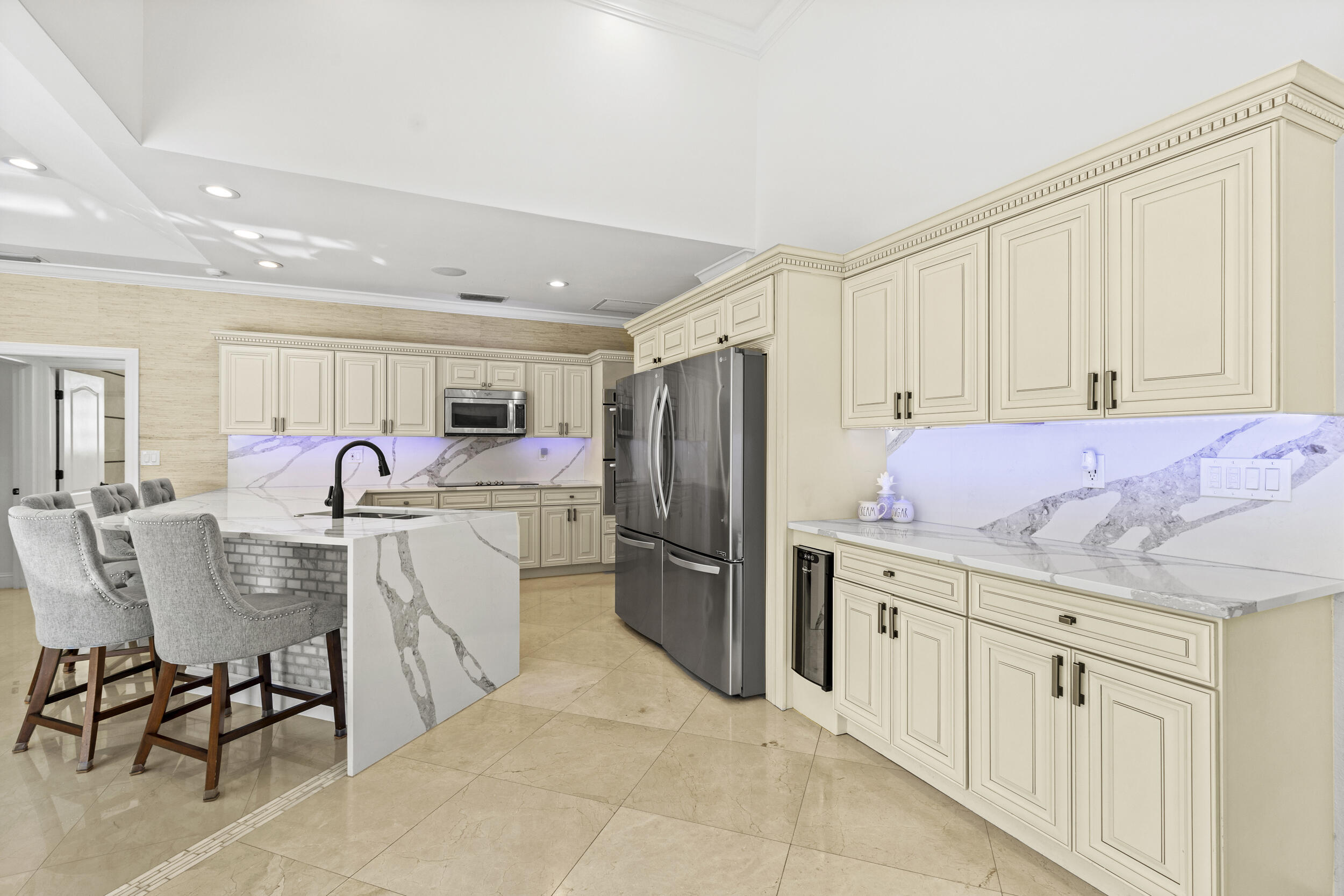 10431 Stonebridge Boulevard Boca Raton, FL 33498 - Photo 16 of 52 a kitchen with white cabinets and stainless steel appliances