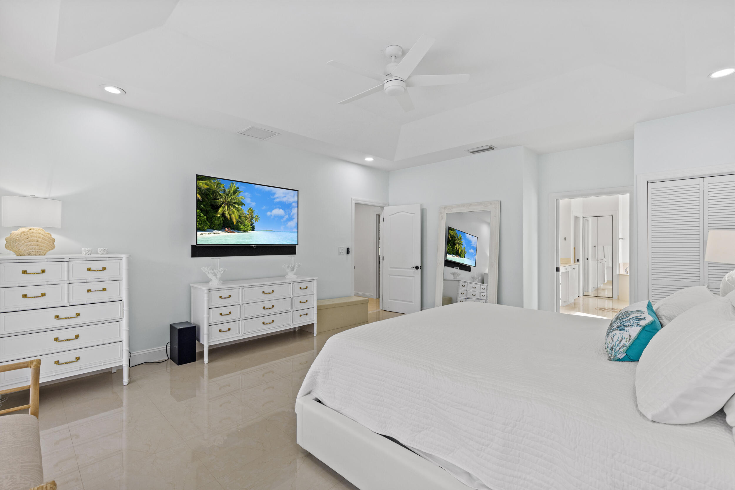 10431 Stonebridge Boulevard Boca Raton, FL 33498 - Photo 17 of 52 a bedroom with a bed a dresser and painting