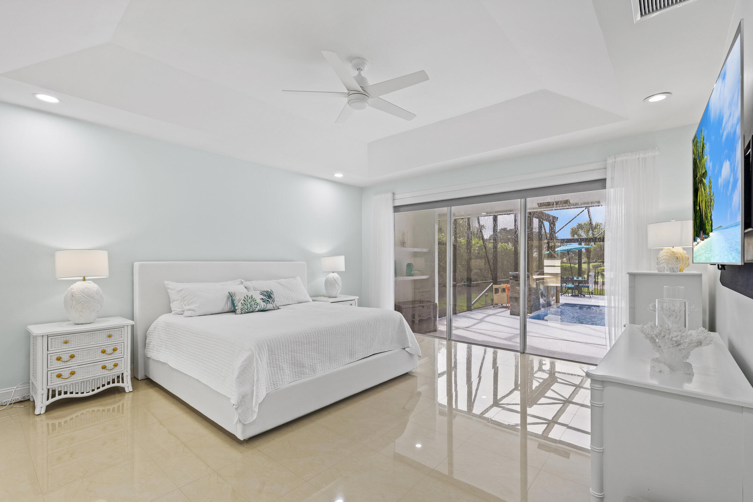 10431 Stonebridge Boulevard Boca Raton, FL 33498 - Photo 20 of 52 a bedroom with a bed and a large window with balcony view
