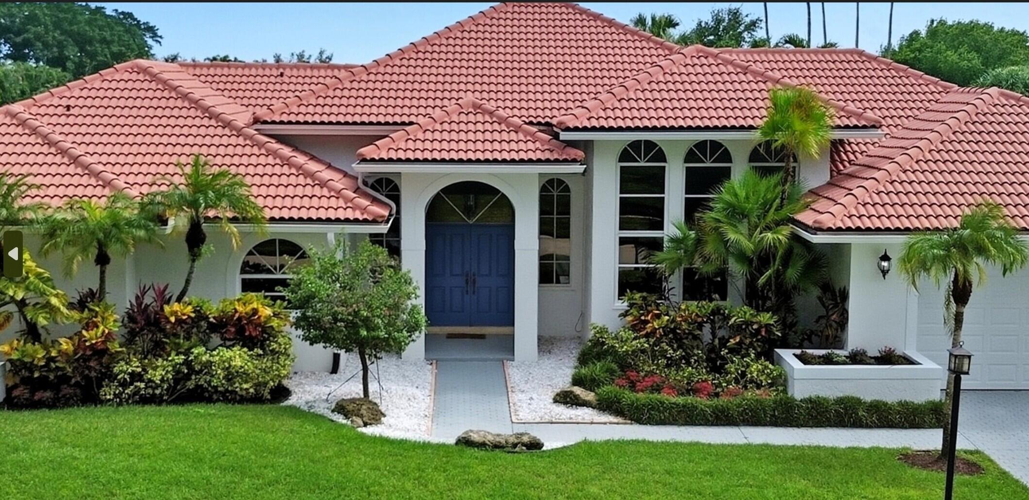 10431 Stonebridge Boulevard Boca Raton, FL 33498 - Photo 2 of 52 a front view of a house with a yard