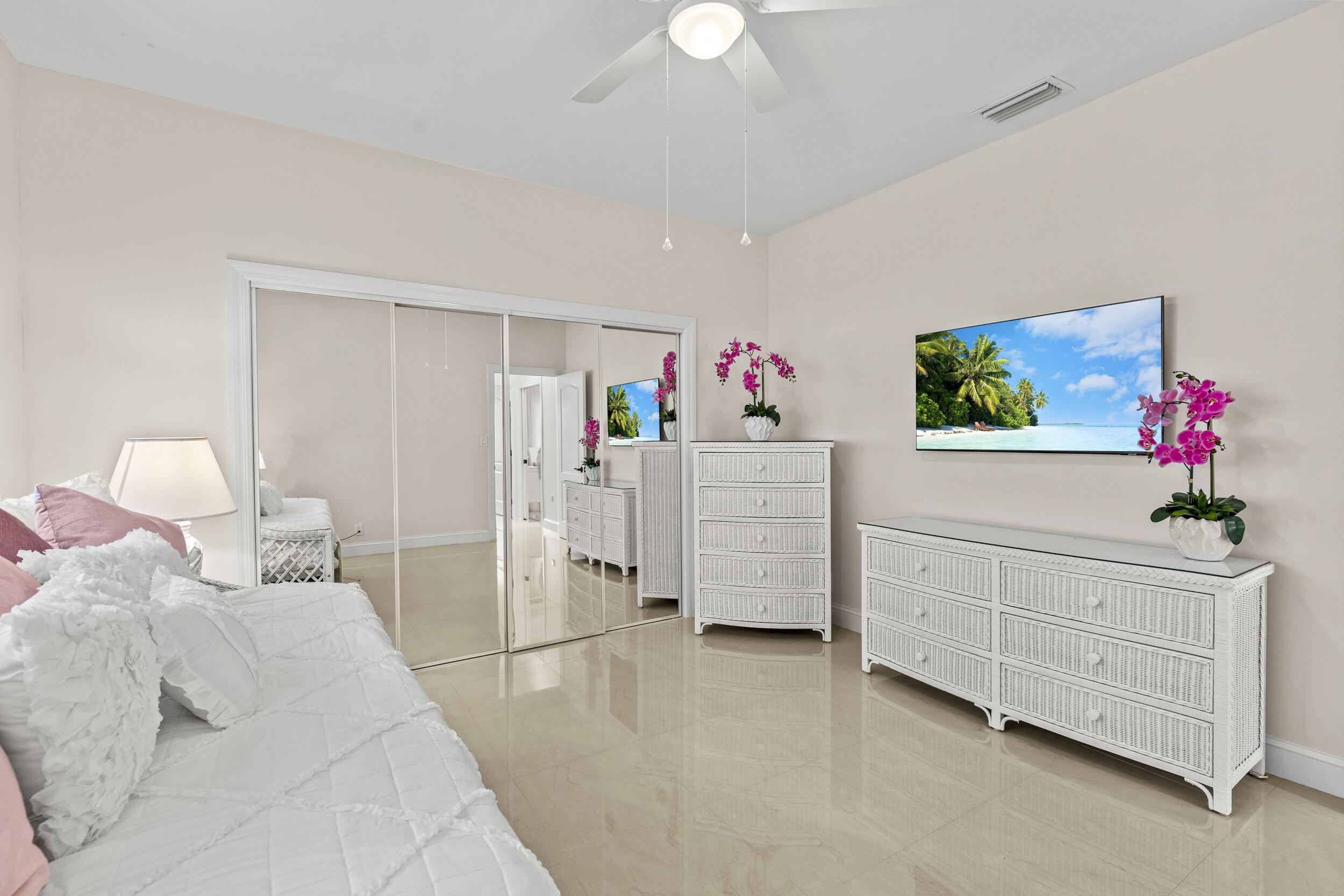 10431 Stonebridge Boulevard Boca Raton, FL 33498 - Photo 33 of 52 a bed room with a bed a dresser and a chandelier