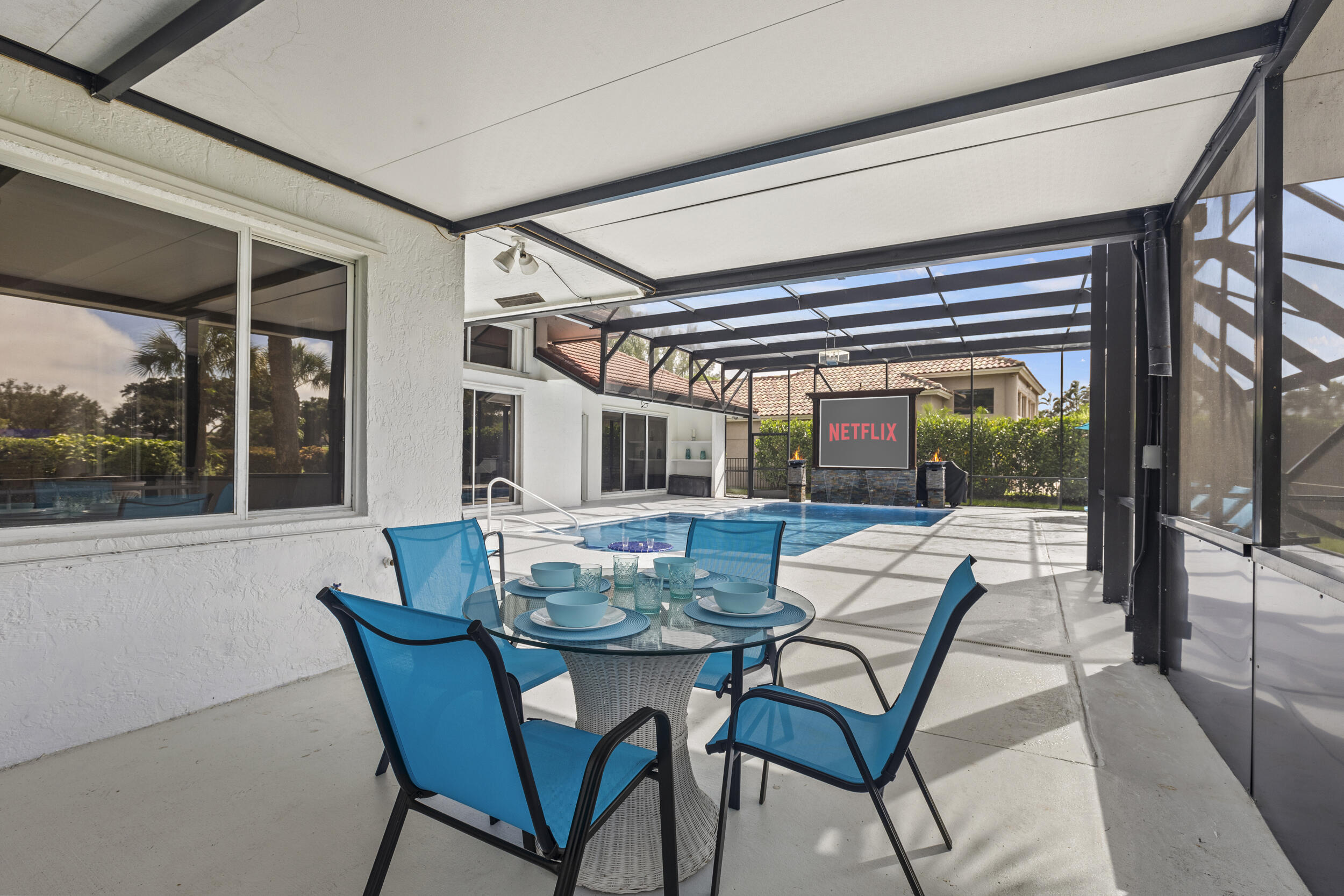 10431 Stonebridge Boulevard Boca Raton, FL 33498 - Photo 41 of 52 a view of an outdoor dining space with a table and chairs