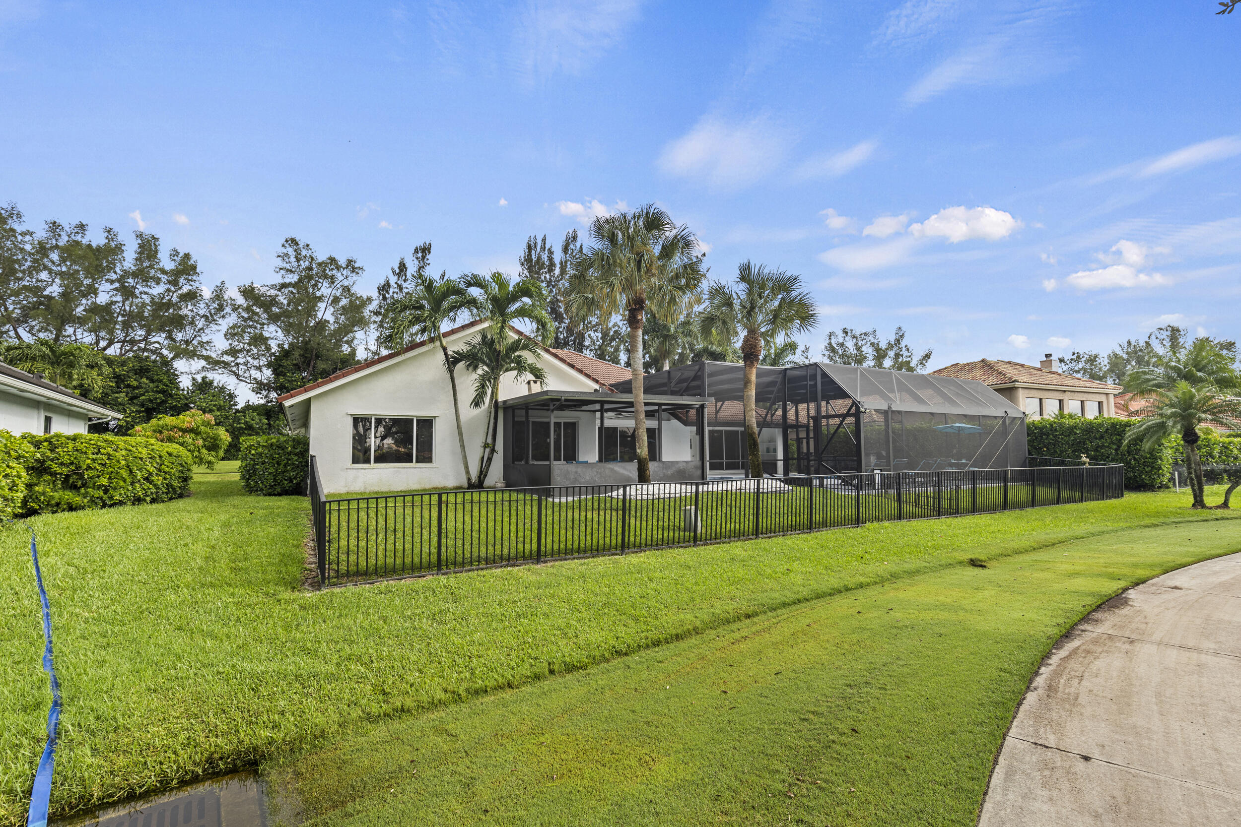10431 Stonebridge Boulevard Boca Raton, FL 33498 - Photo 49 of 52 a view of a house with a big yard and large trees