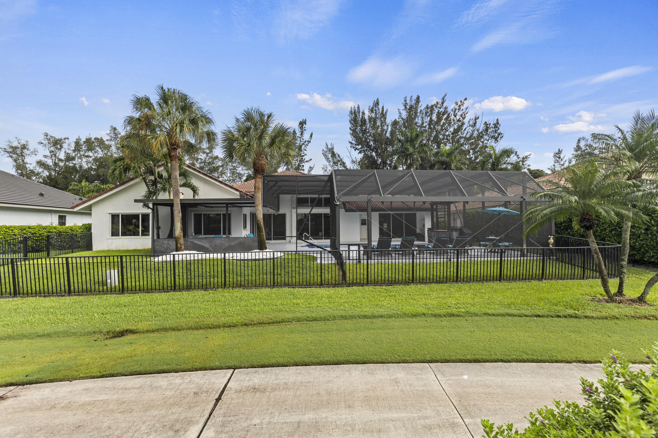 10431 Stonebridge Boulevard Boca Raton, FL 33498 - Photo 50 of 52 a front view of a house with a yard