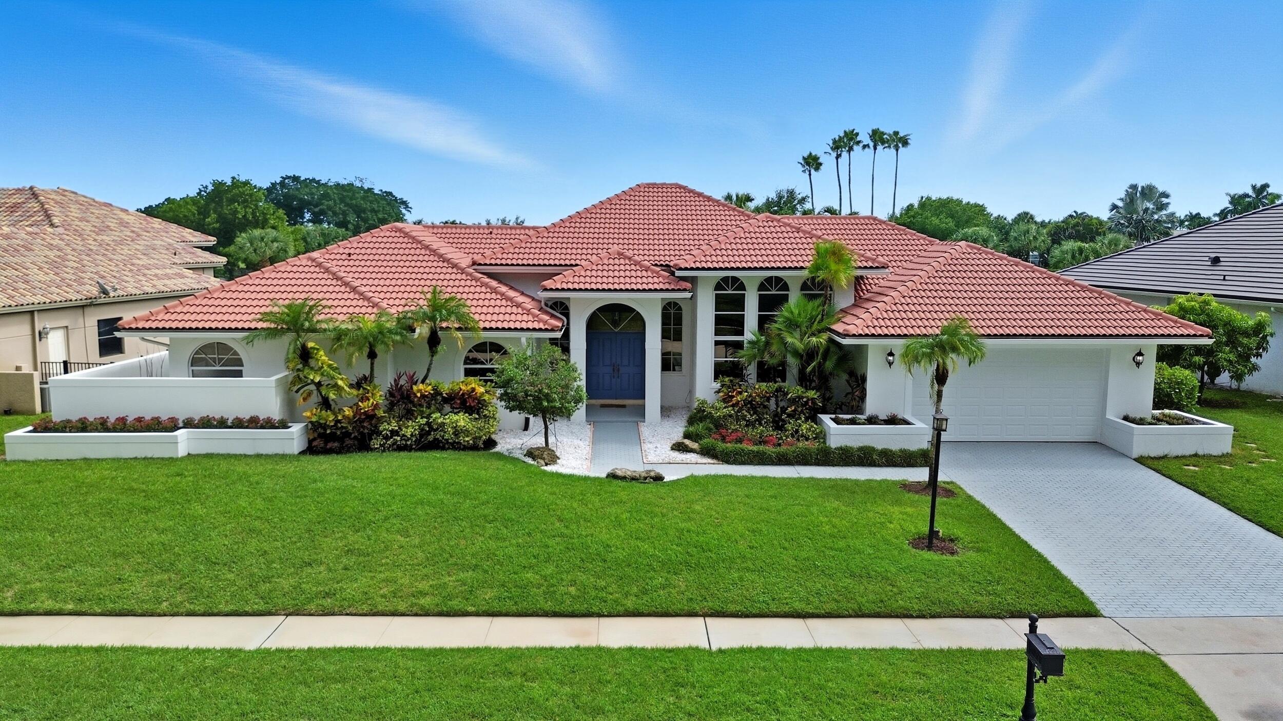 10431 Stonebridge Boulevard Boca Raton, FL 33498 - Photo 52 of 52 a front view of a house with a garden