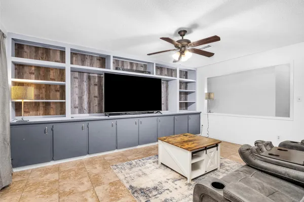 a living room with furniture workspace and a flat screen tv