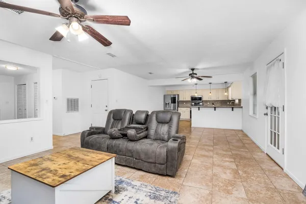 a living room with furniture and kitchen view