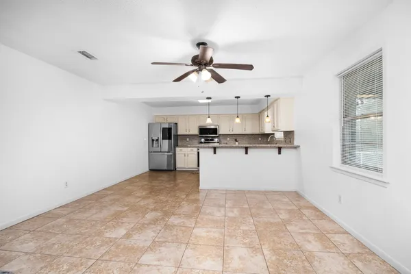 a view of a kitchen with a sink and cabinets