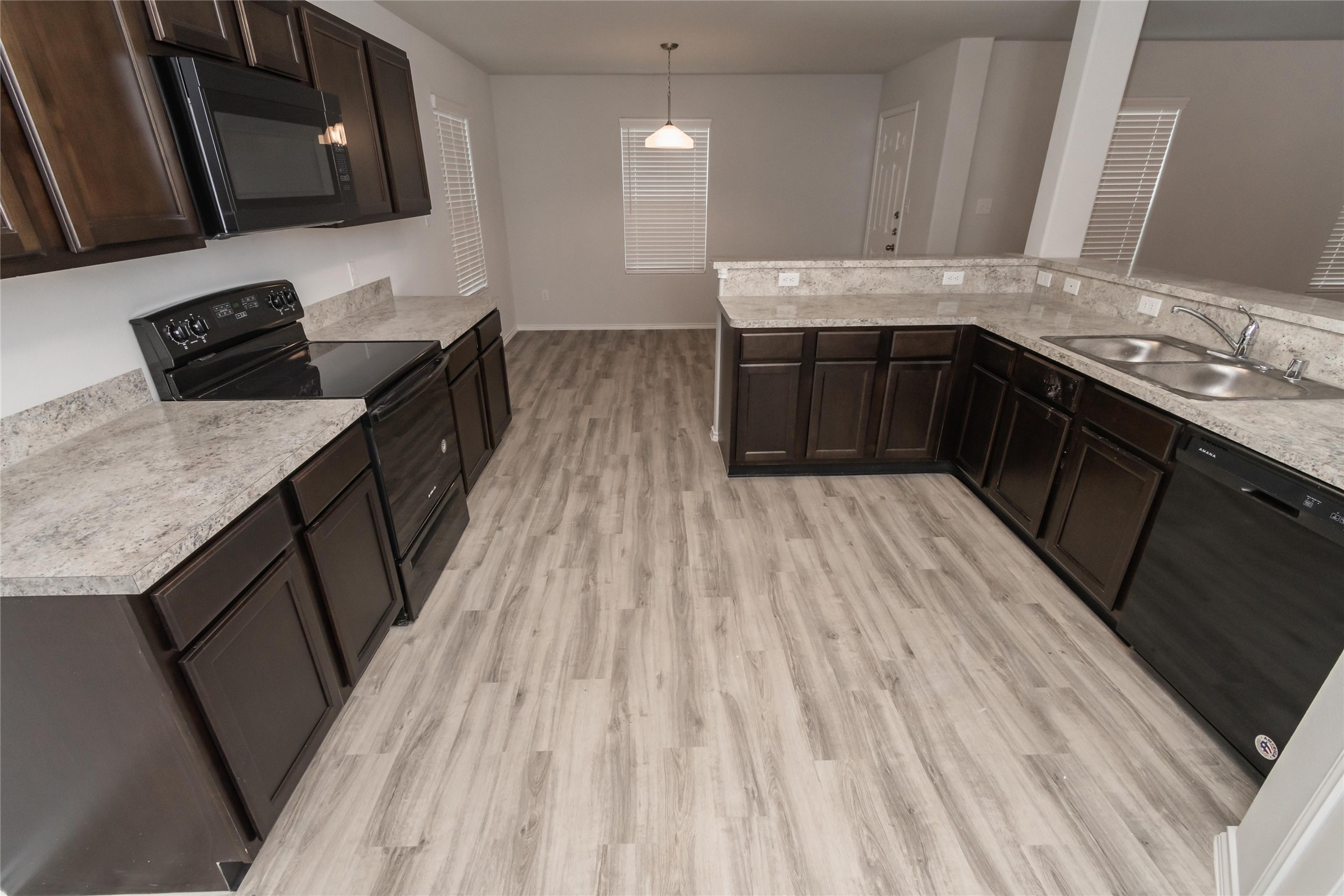 18607 Bell Ravine Drive Katy, TX 77449 - Photo 4 of 10 a kitchen with stainless steel appliances granite countertop a sink stove and refrigerator