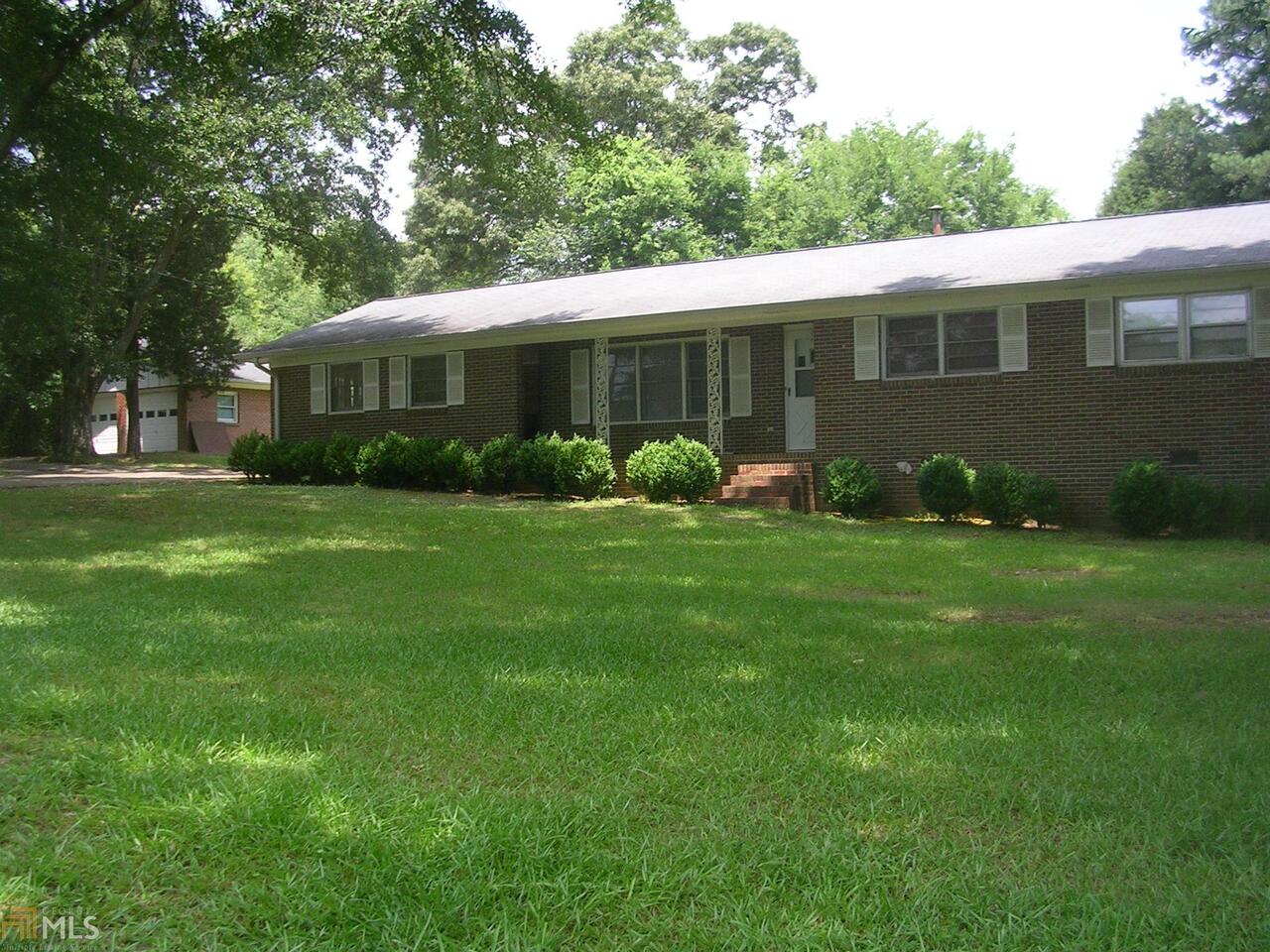 1320 Prior Station Road Cedartown, GA 30125 - Photo 1 of 1 a view of a house with a yard and sitting area