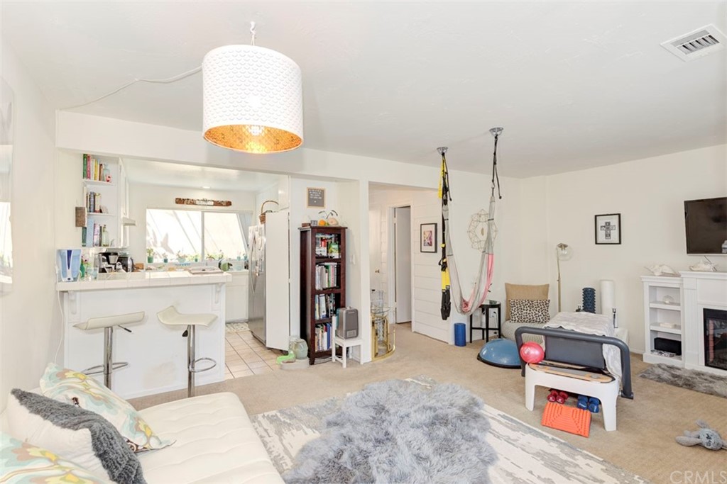 239 Avenida Santa Barbara San Clemente, CA 92672 - Photo 16 of 29 a living room with furniture a flat screen tv and kitchen view