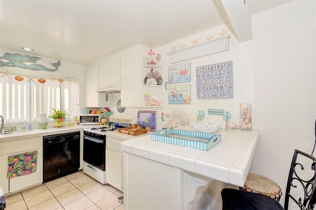 239 Avenida Santa Barbara San Clemente, CA 92672 - Photo 8 of 29 a kitchen with a sink stove and cabinets