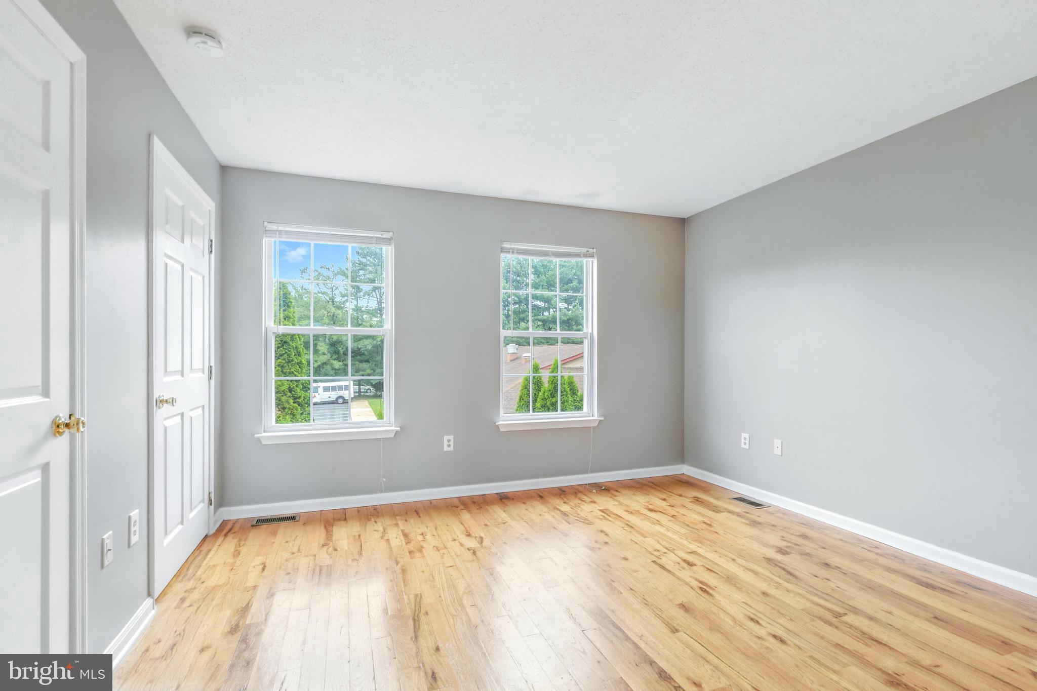 111 Gateway Drive Newark, DE 19711 - Photo 12 of 20 an empty room with wooden floor and windows