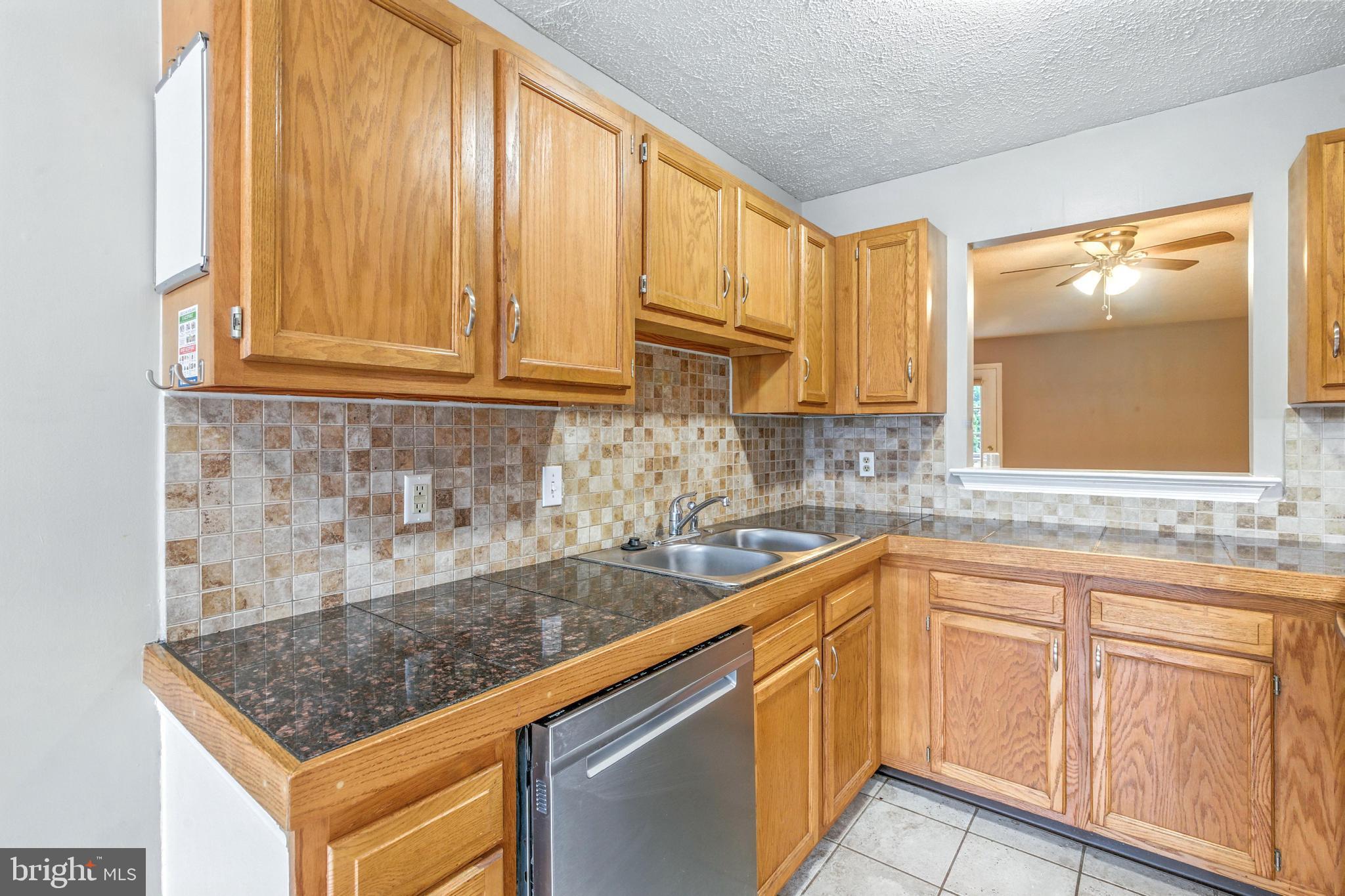 111 Gateway Drive Newark, DE 19711 - Photo 3 of 20 a kitchen with stainless steel appliances granite countertop a sink and cabinets