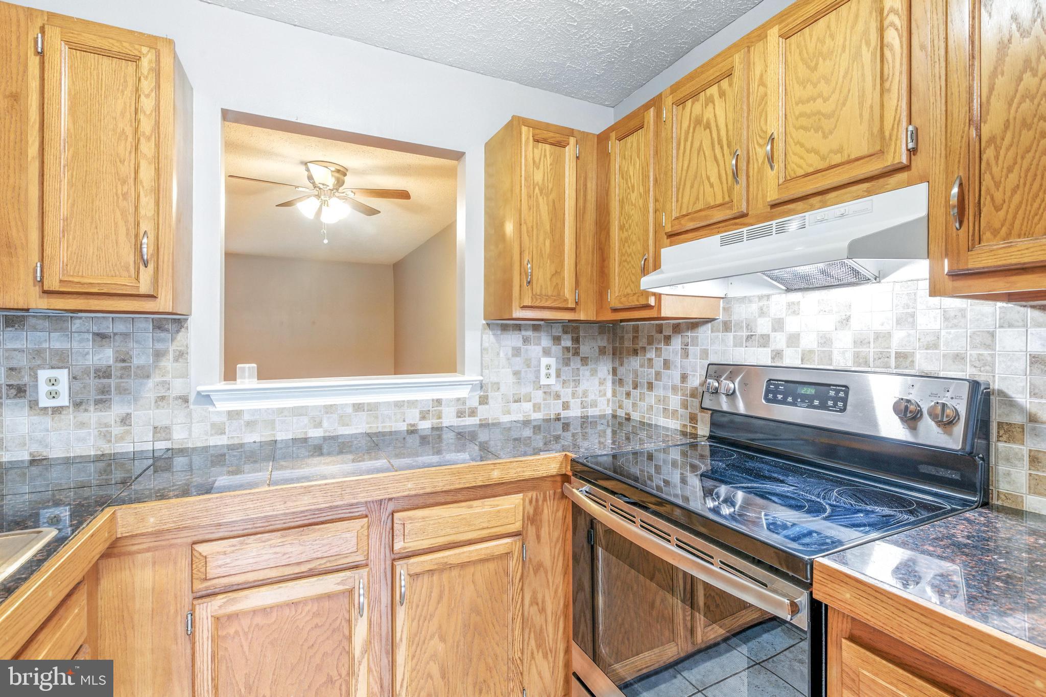 111 Gateway Drive Newark, DE 19711 - Photo 4 of 20 a kitchen with stainless steel appliances granite countertop a sink and a stove