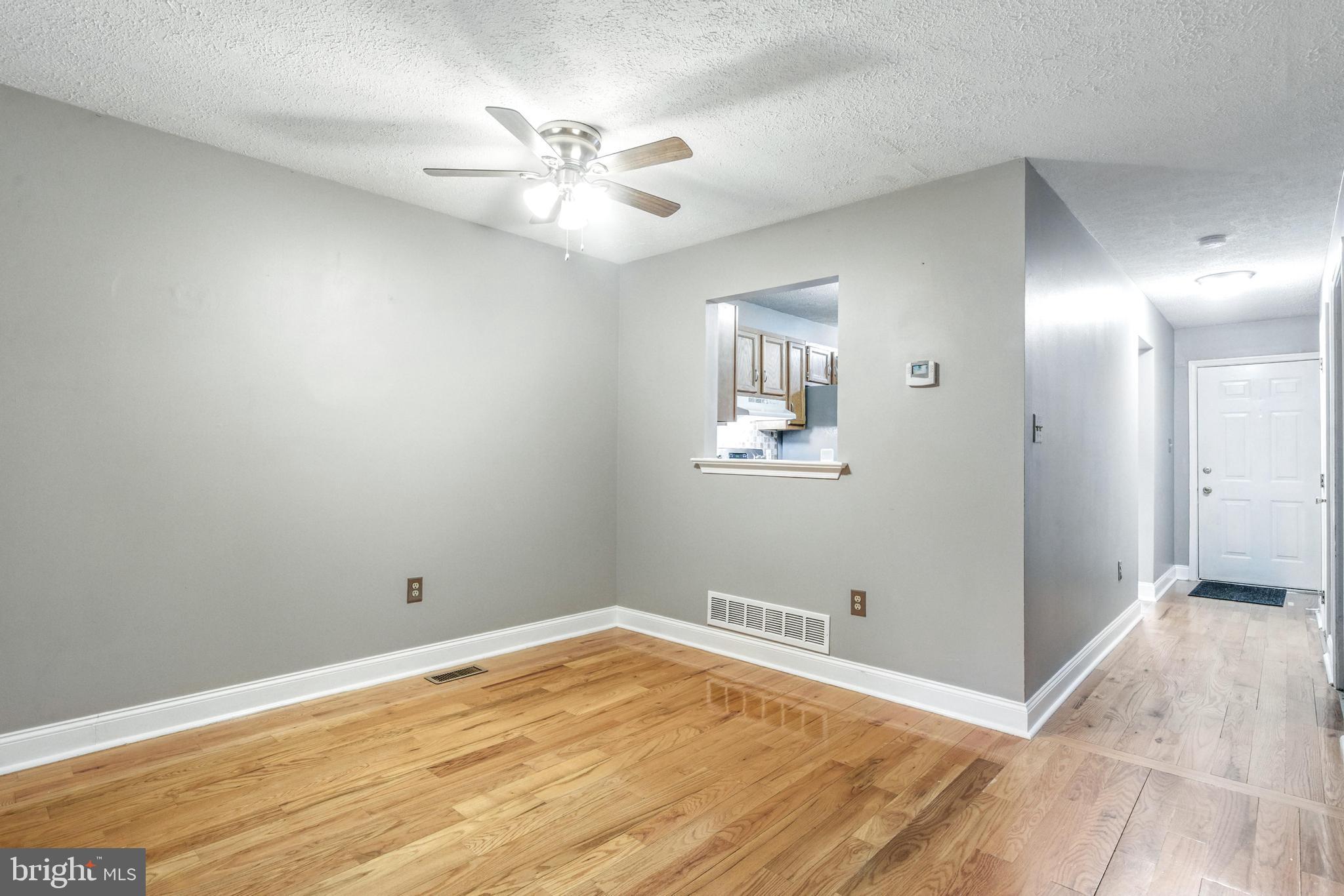 111 Gateway Drive Newark, DE 19711 - Photo 7 of 20 wooden floor in an empty room with a mirror