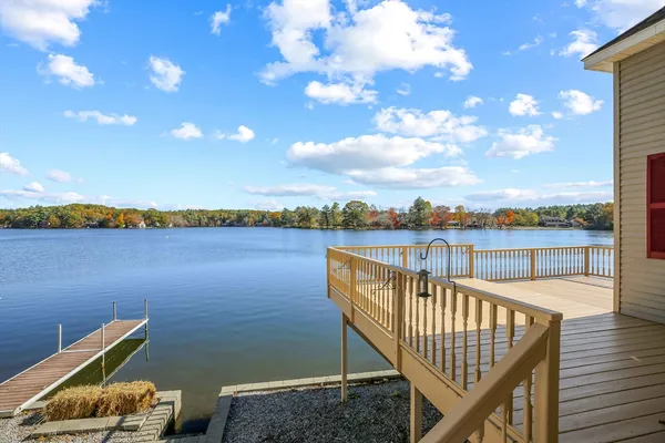 a view of a balcony with lake view and wooden floor