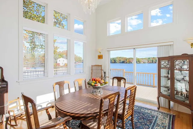 a view of a dining room with furniture large windows and wooden floor