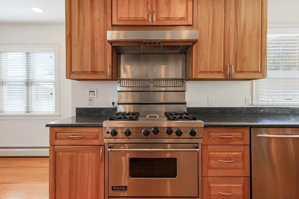 a stove top oven sitting inside of a kitchen