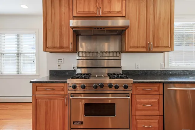a stove top oven sitting inside of a kitchen