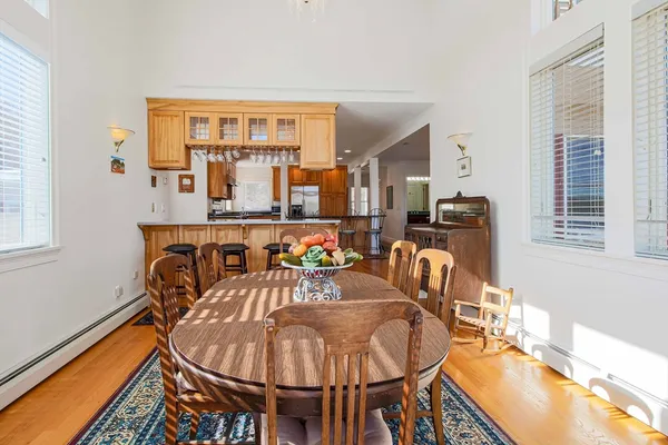 a dining room with furniture and wooden floor