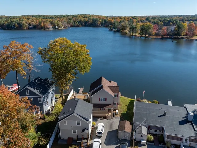 an aerial view of a house with a lake view