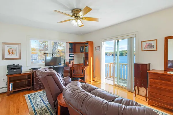 a living room with furniture a ceiling fan and a window