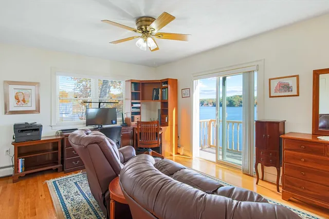 a living room with furniture a ceiling fan and a window