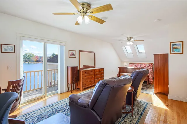 a view of a livingroom with furniture wooden floor and a ceiling fan