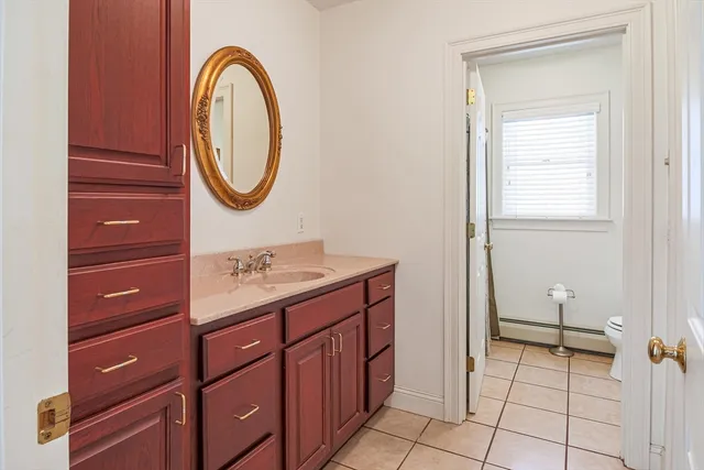 a bathroom with a sink a toilet and a mirror