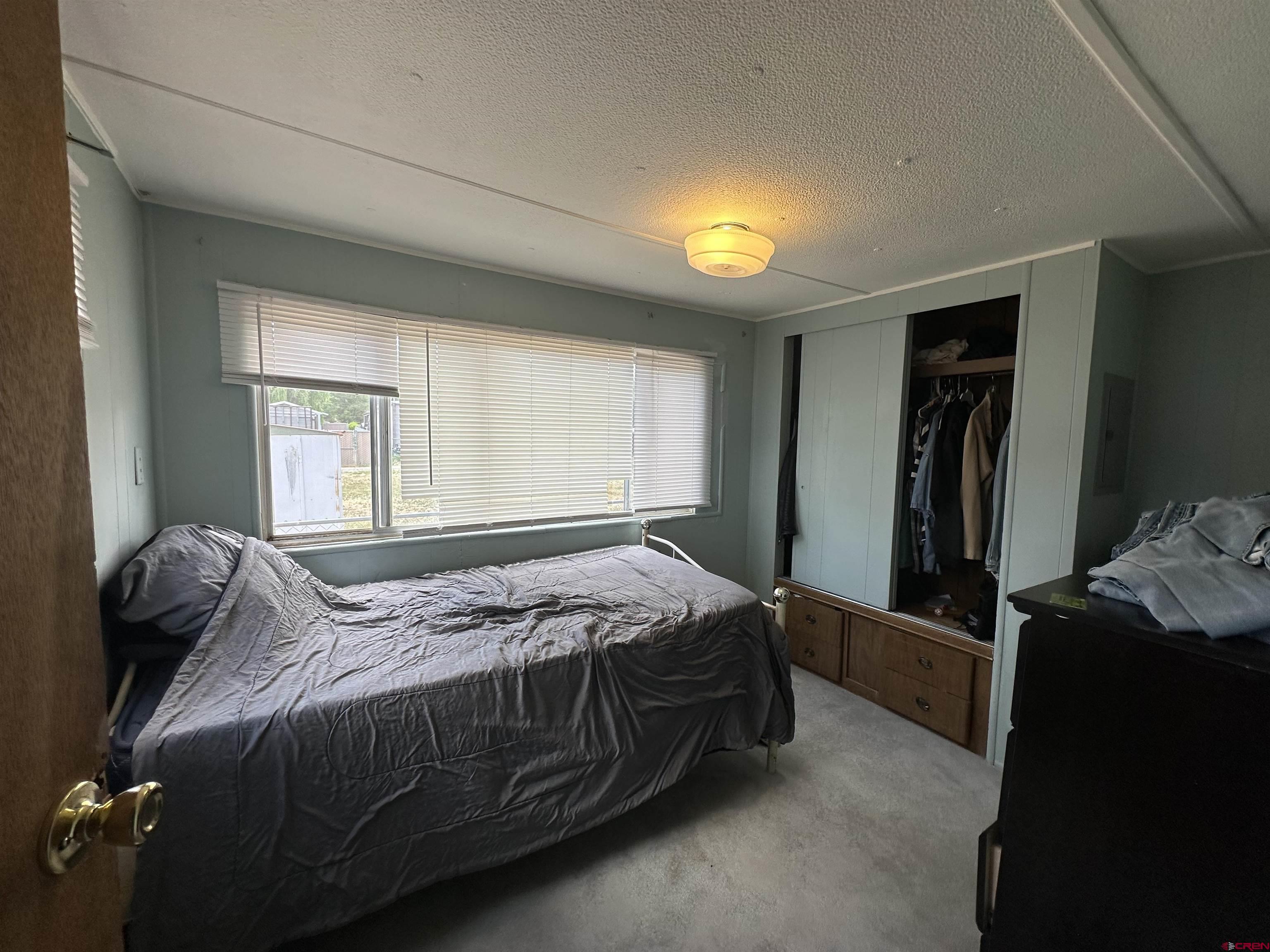 609 South Beech Street Cortez, CO 81321 - Photo 8 of 8 a bedroom with a bed and a window