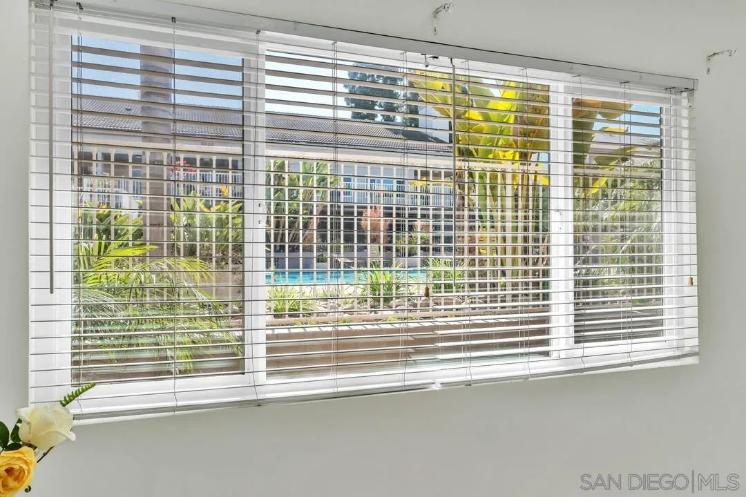 8536 Via Mallorca, Unit B La Jolla, CA 92037 - Photo 17 of 34 a view of a glass door with a roof