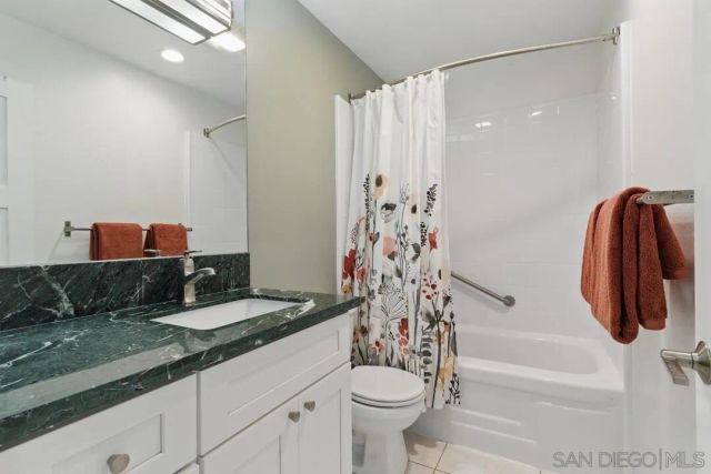 a bathroom with a sink a toilet and a shower